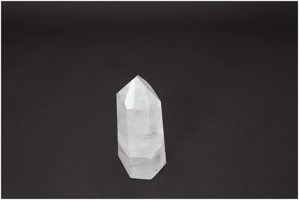 Lemurian Quartz Obelisk on black background, showcasing its unique properties linked to chakras and zodiac signs for spiritual needs.