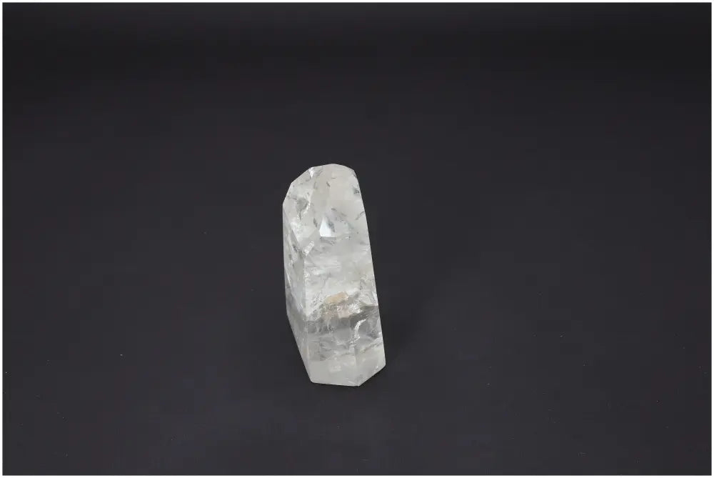 Lemurian quartz obelisk against dark background, known for its unique spiritual properties, chakra, and zodiac associations.