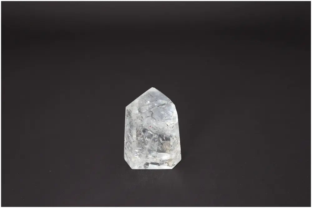 Lemurian Quartz Obelisk against dark background, showcasing its unique energetic and spiritual properties linked to chakras.