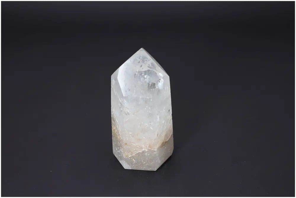 Lemurian Quartz Obelisk against a dark background, showcasing its unique clarity and energetic properties for chakra alignment.