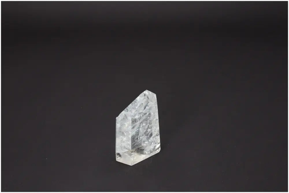 Lemurian Quartz Obelisk on dark background, showcasing its unique crystal properties for chakra and zodiac alignment.