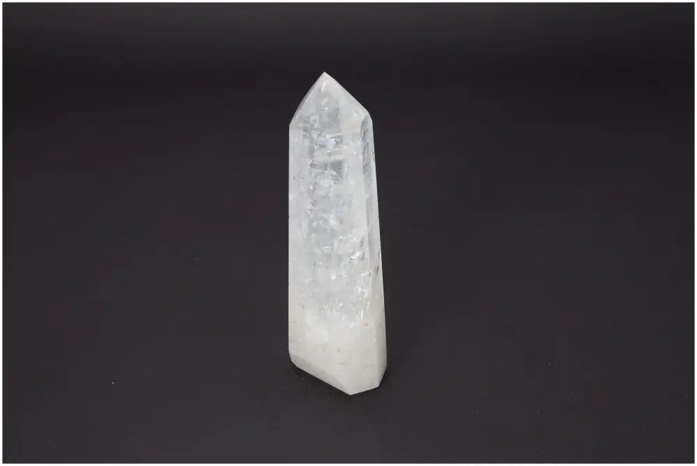 Lemurian Quartz Obelisk on dark background, showcasing unique properties for chakra and zodiac energy alignment.