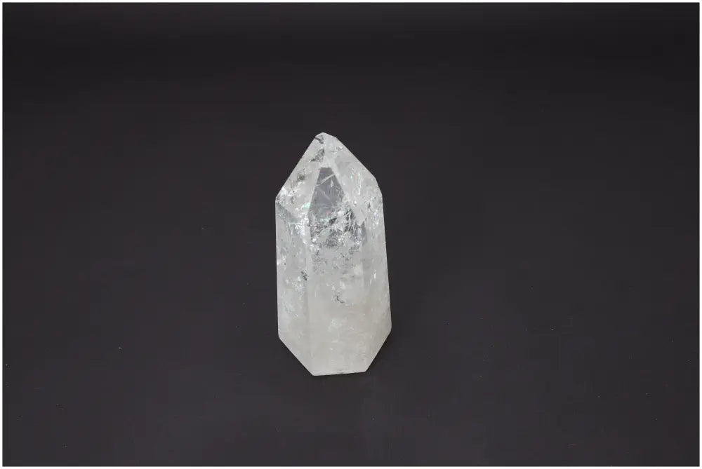 Lemurian Quartz Obelisk on black background, known for its unique properties affecting chakras and zodiac signs, enhancing spiritual energy.