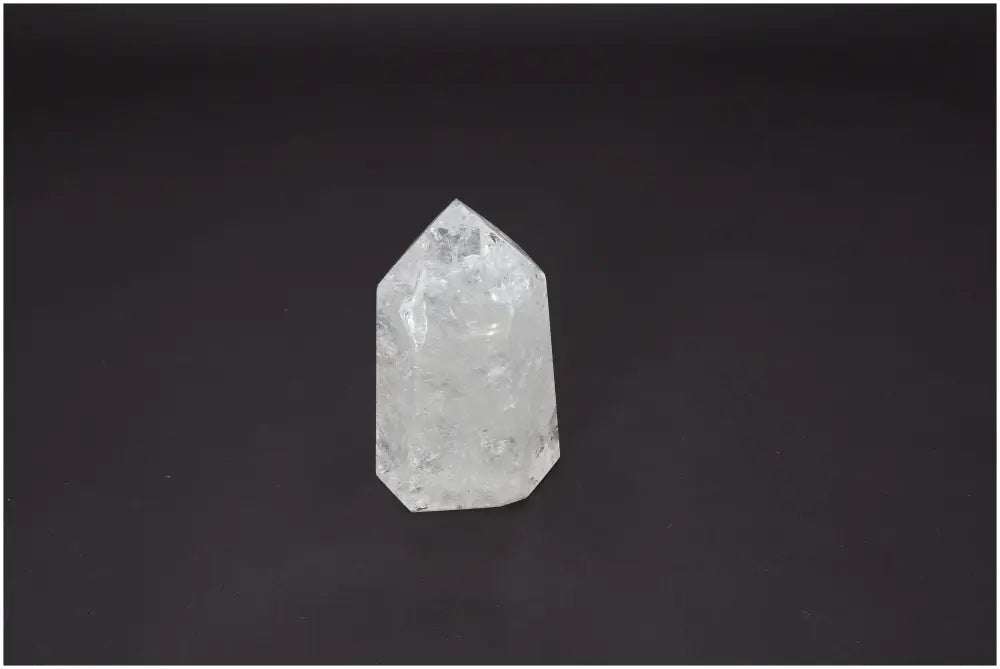 Lemurian Quartz Obelisk for chakra alignment and zodiac connection on dark background