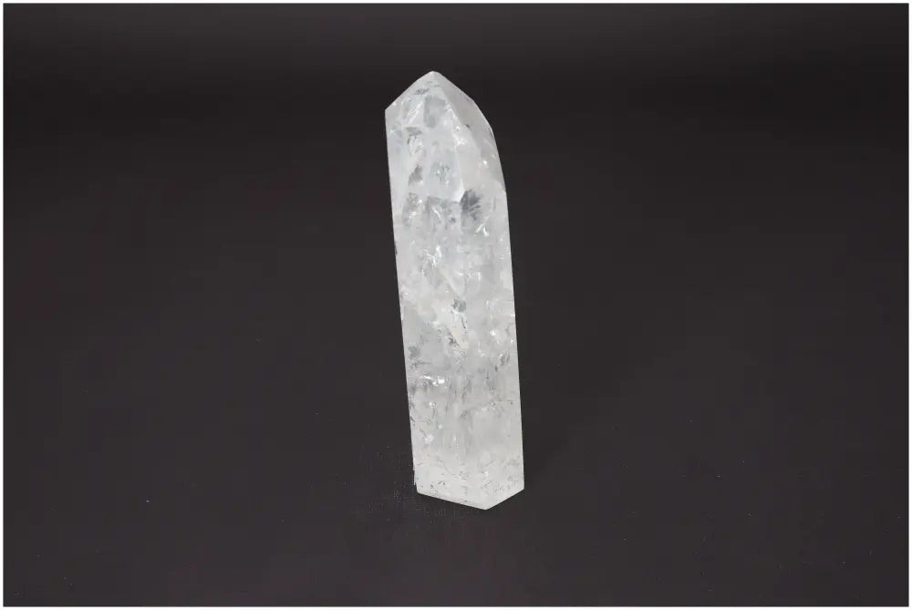 Lemurian Quartz Obelisk crystal on black background, promoting chakra alignment and spiritual healing.