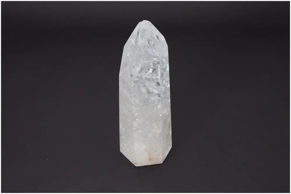 Lemurian Quartz Obelisk on black background, known for unique energetic properties and various chakra associations. Ideal for spiritual healing.