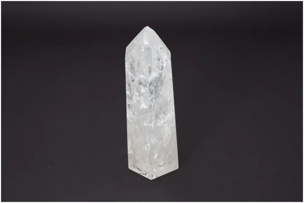 Lemurian Quartz Obelisk crystal, known for its unique energetic properties, associated with chakras and zodiac signs, on black background.
