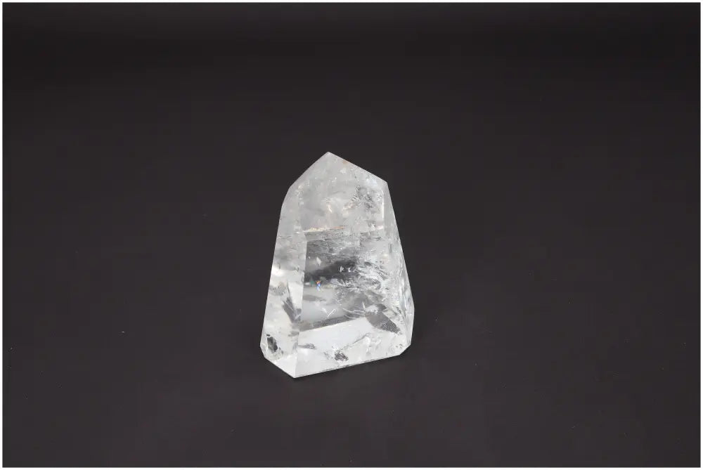 Lemurian Quartz Obelisk against dark background, showcasing unique energetic and spiritual properties linked to chakras and zodiac signs.