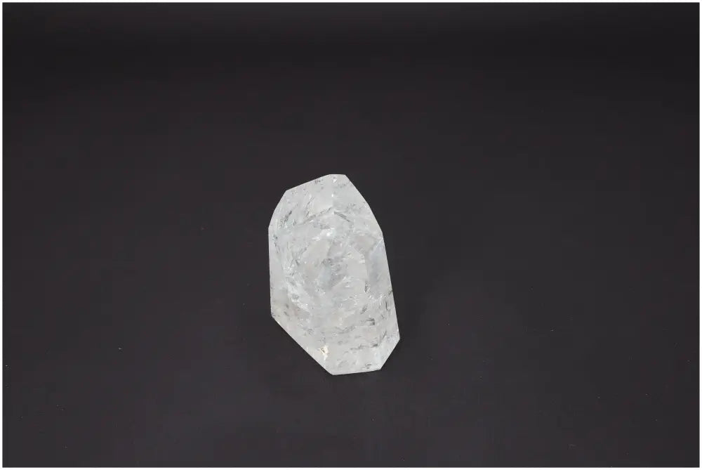 Lemurian Quartz Obelisk against dark background, showcasing its unique energetic and spiritual properties for chakras and zodiac alignment.