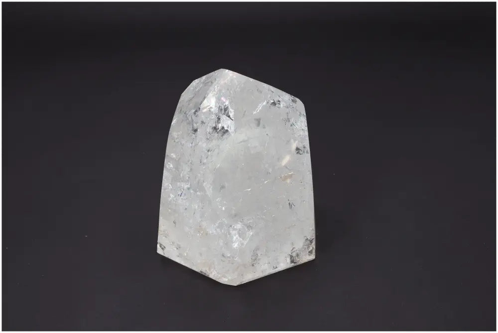 Lemurian Quartz Obelisk crystal with unique energetic properties for chakras and zodiac signs on a dark background.