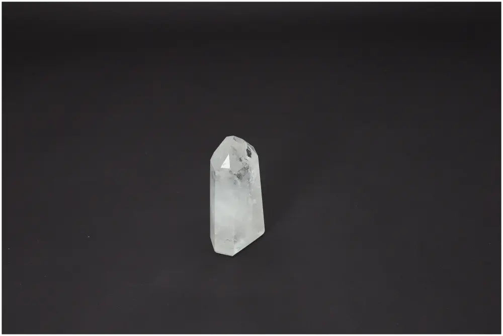 Lemurian Quartz Obelisk crystal on dark background, known for its unique properties and chakra alignment for spiritual support.