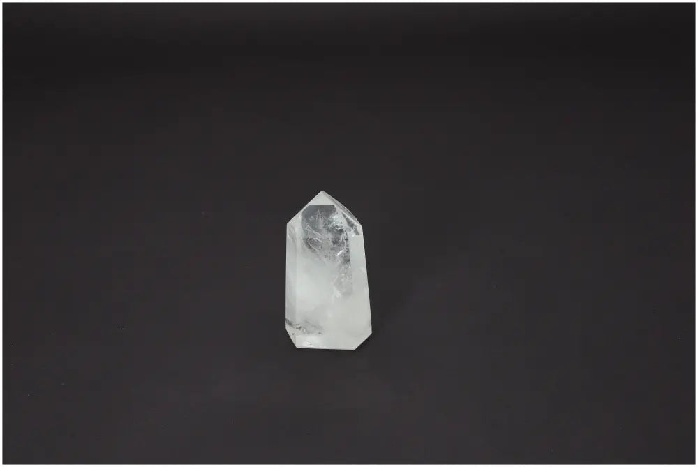 Lemurian Quartz Obelisk on dark background, showcasing unique energetic and spiritual properties, linking to chakras and zodiac signs.