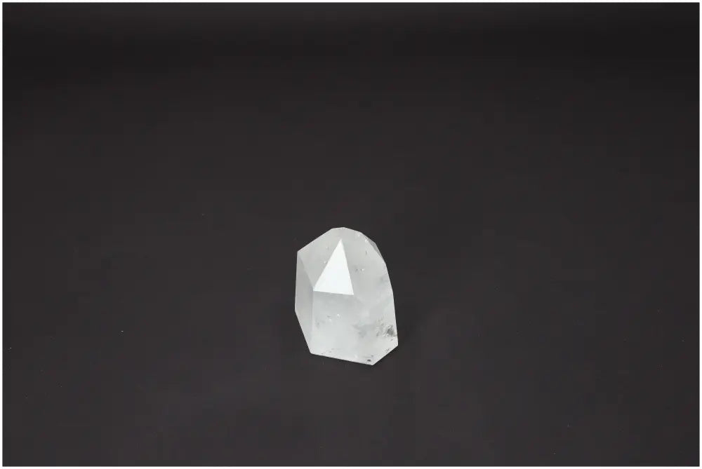 Lemurian Quartz Obelisk crystal on dark background, known for chakra alignment and spiritual energy, enhancing body and soul wellness.