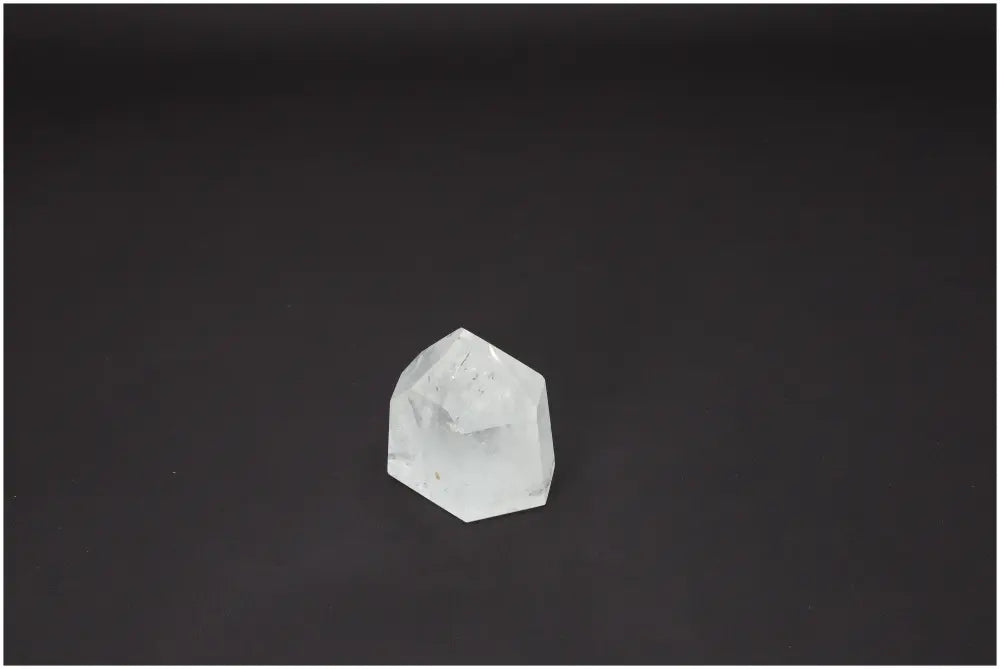 Lemurian Quartz Obelisk against dark background, highlighting its spiritual and energetic properties for chakra healing.