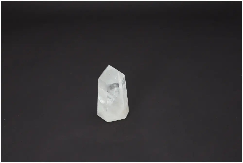 Lemurian Quartz Obelisk crystal on dark background, showcasing its unique properties for spiritual and energetic support.