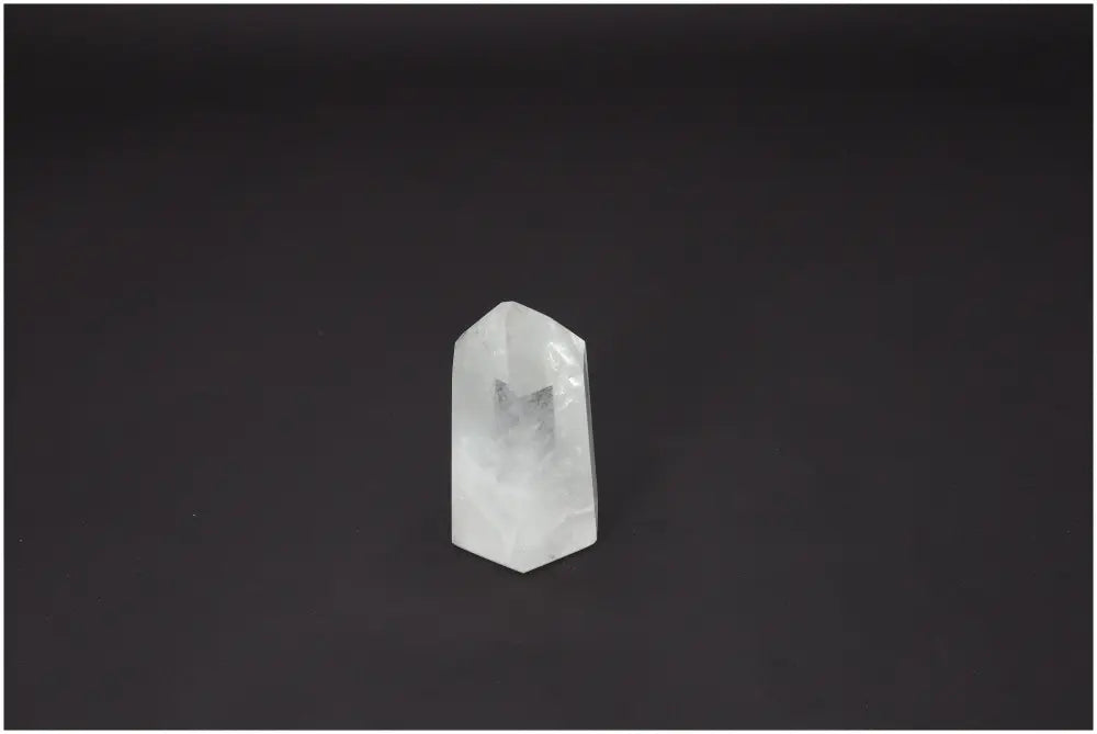 Lemurian Quartz Obelisk on dark background, showcasing unique crystal structure and spiritual energy properties.