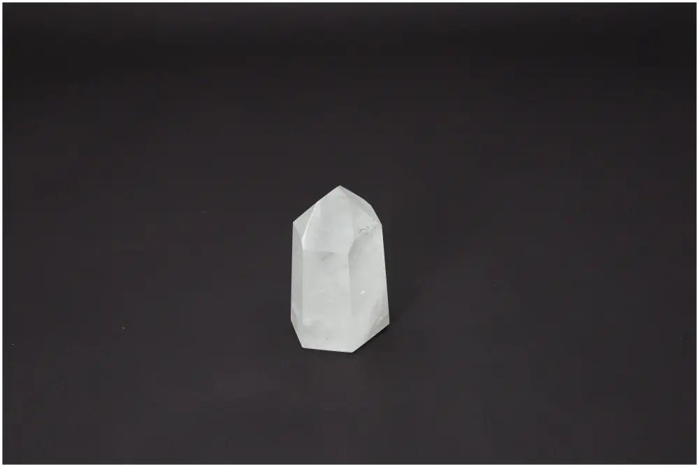 Lemurian Quartz Obelisk against a dark background, highlighting its spiritual and energetic properties linked to chakras and zodiac signs.