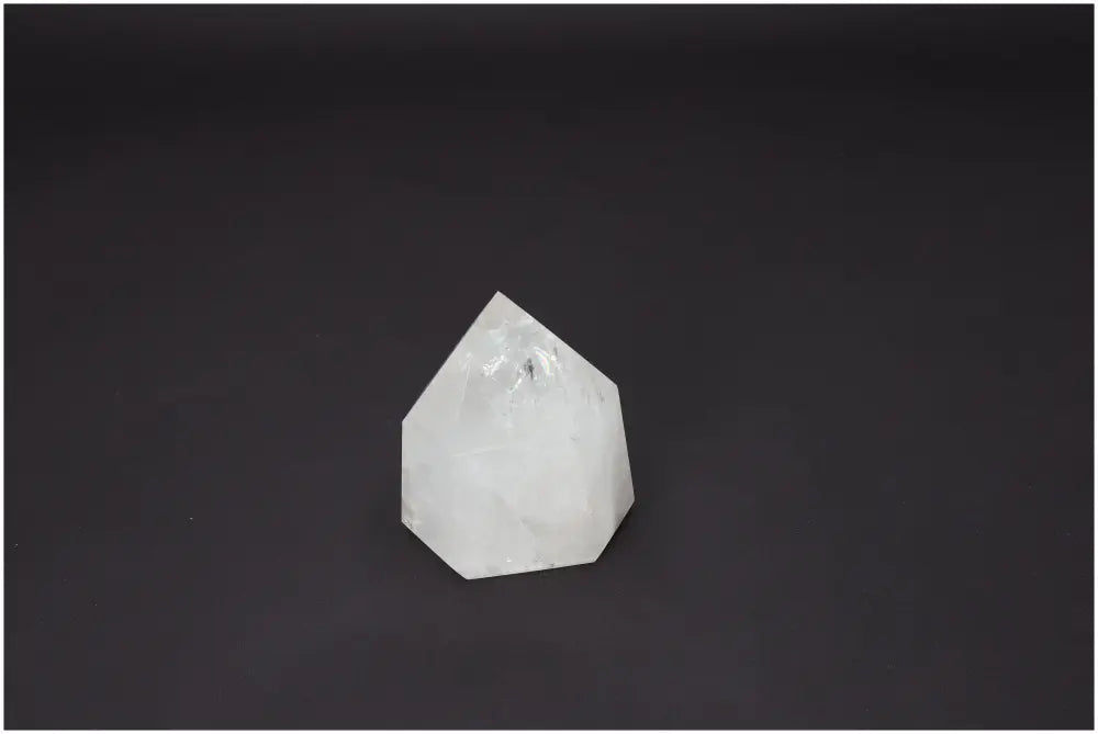 Lemurian Quartz Obelisk against dark background, highlighting its spiritual properties and chakra alignment.