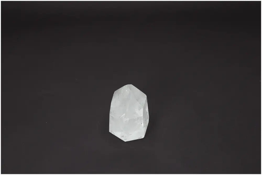 Lemurian Quartz Obelisk on black background, associated with spiritual healing, chakras, and zodiac energies.