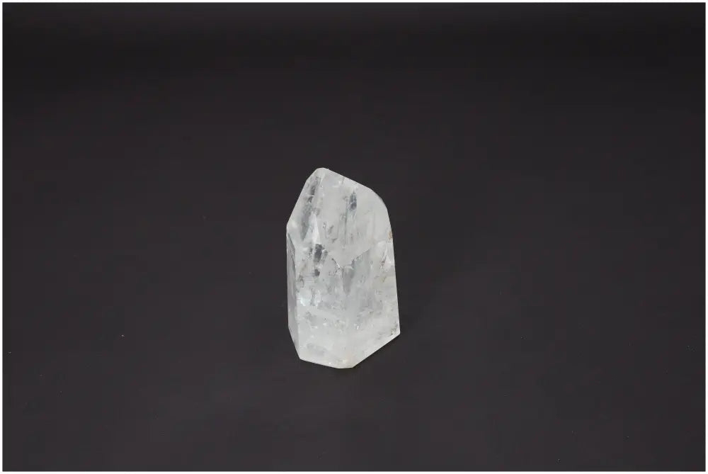 Lemurian Quartz Obelisk with energetic healing properties on a black background