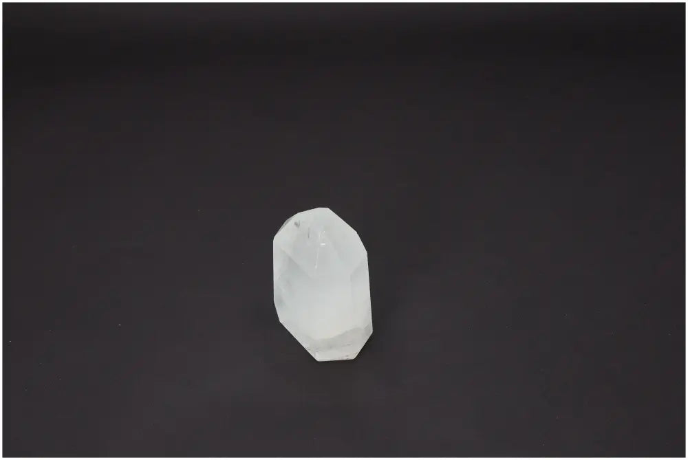 Lemurian Quartz Obelisk on black background, spiritual healing crystal with unique energetic properties.