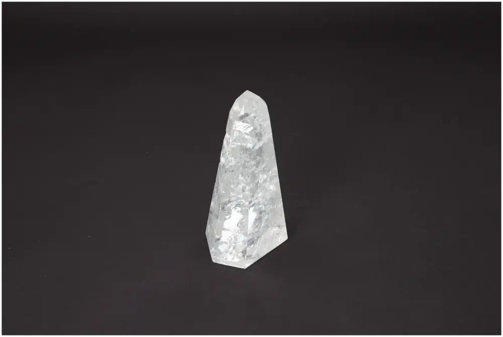 Lemurian Quartz Obelisk on black background, showcasing its clarity and spiritual properties, ideal for chakra and zodiac energy alignment.