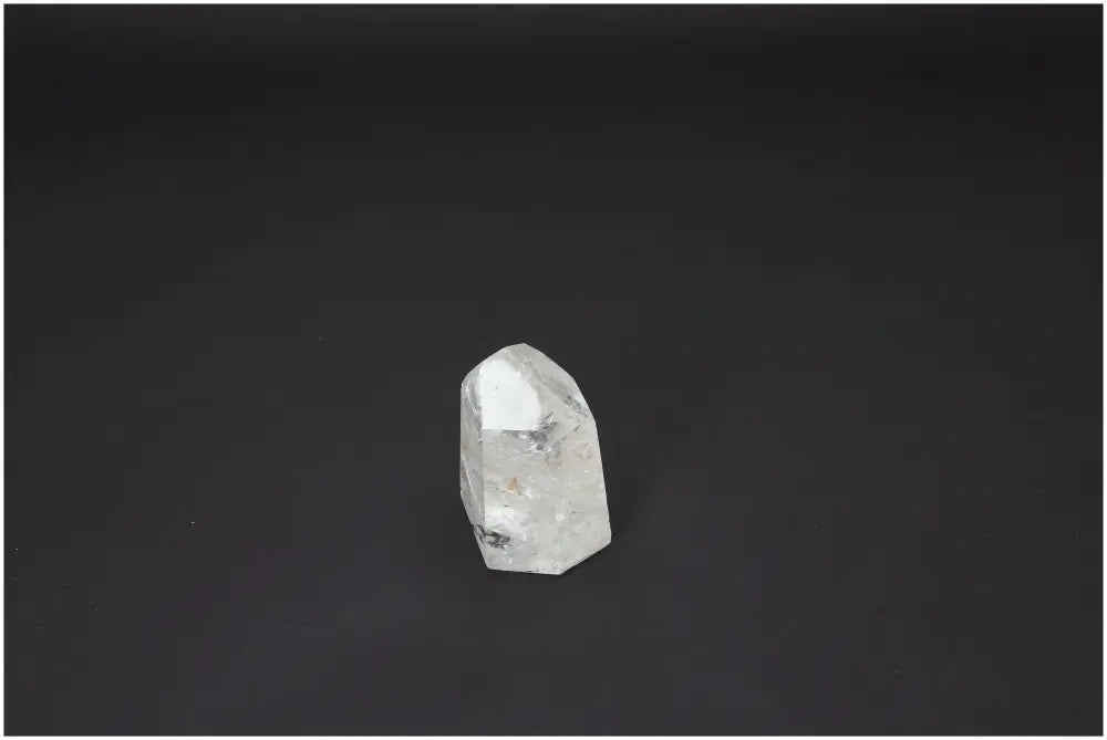 Lemurian Quartz Obelisk against a dark background showcasing its unique crystal structure and spiritual properties.
