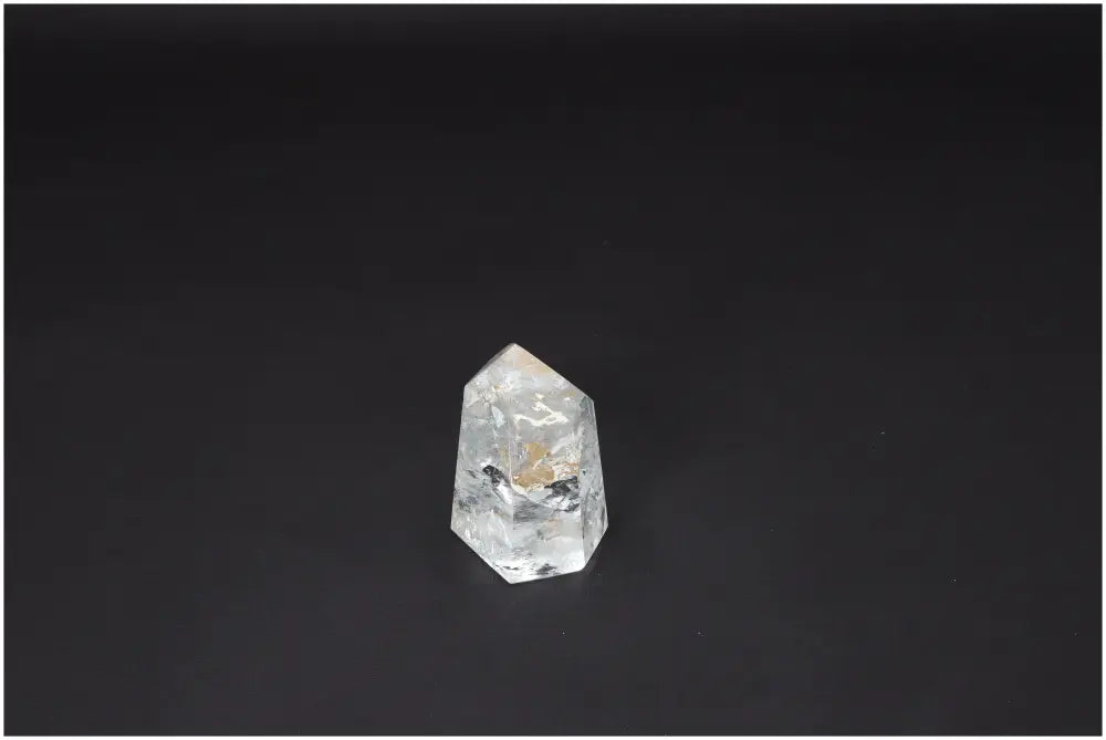 Lemurian Quartz Obelisk on black background, showcasing unique properties and spiritual connections with chakras and zodiac signs.