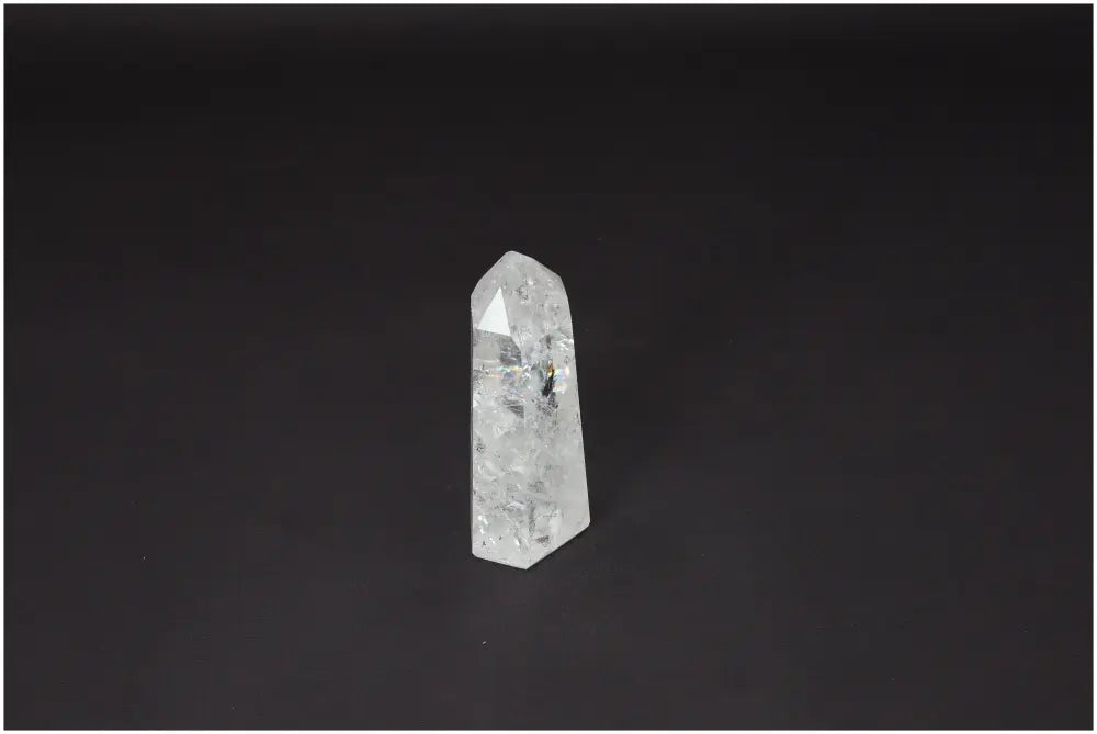 Lemurian Quartz Obelisk crystal for chakra balancing and zodiac alignment against dark background.
