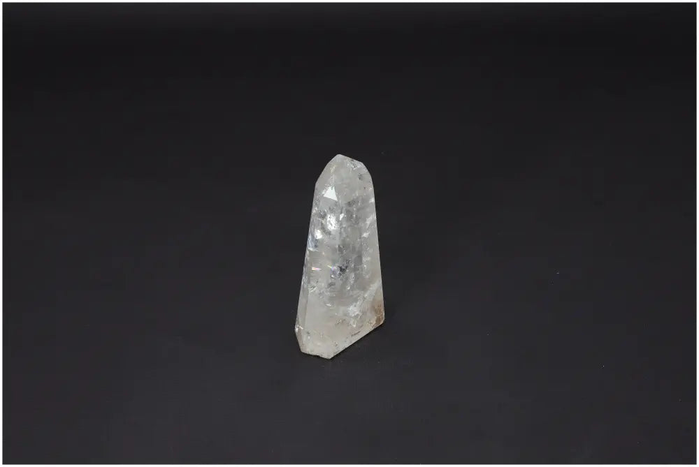 Lemurian Quartz Obelisk on a dark background, known for enhancing chakra energy and supporting spiritual needs.