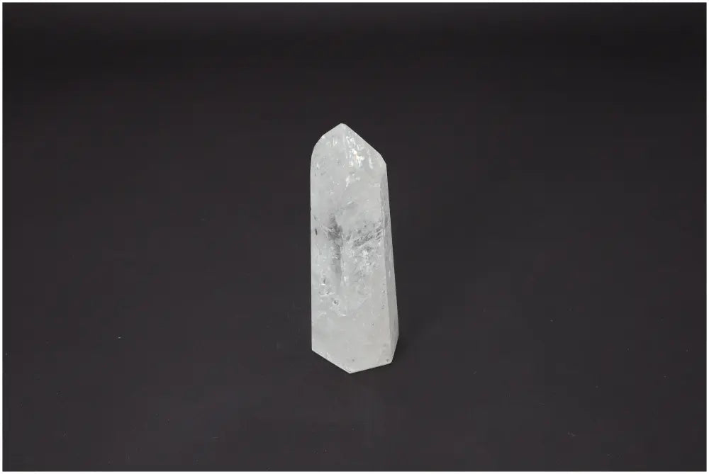 Lemurian Quartz Obelisk on a dark background highlighting its clarity and spiritual properties for chakra and zodiac alignment.