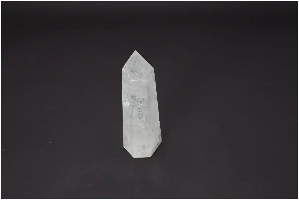 Lemurian Quartz Obelisk with unique energy properties for chakra and zodiac alignment against a dark background.