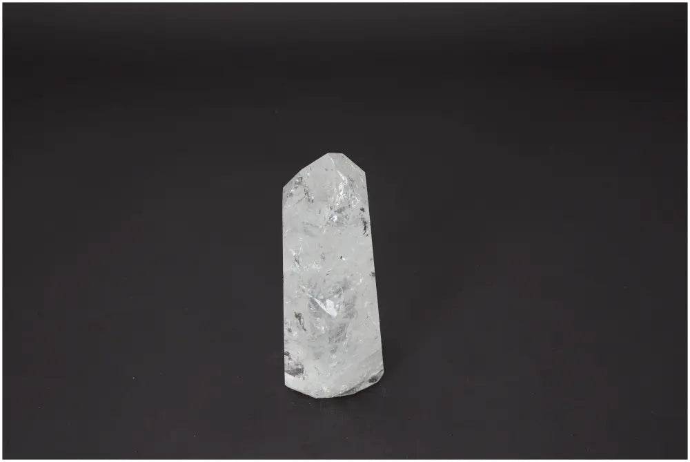 Lemurian Quartz Obelisk on black background, known for its unique energetic properties and chakra alignment.