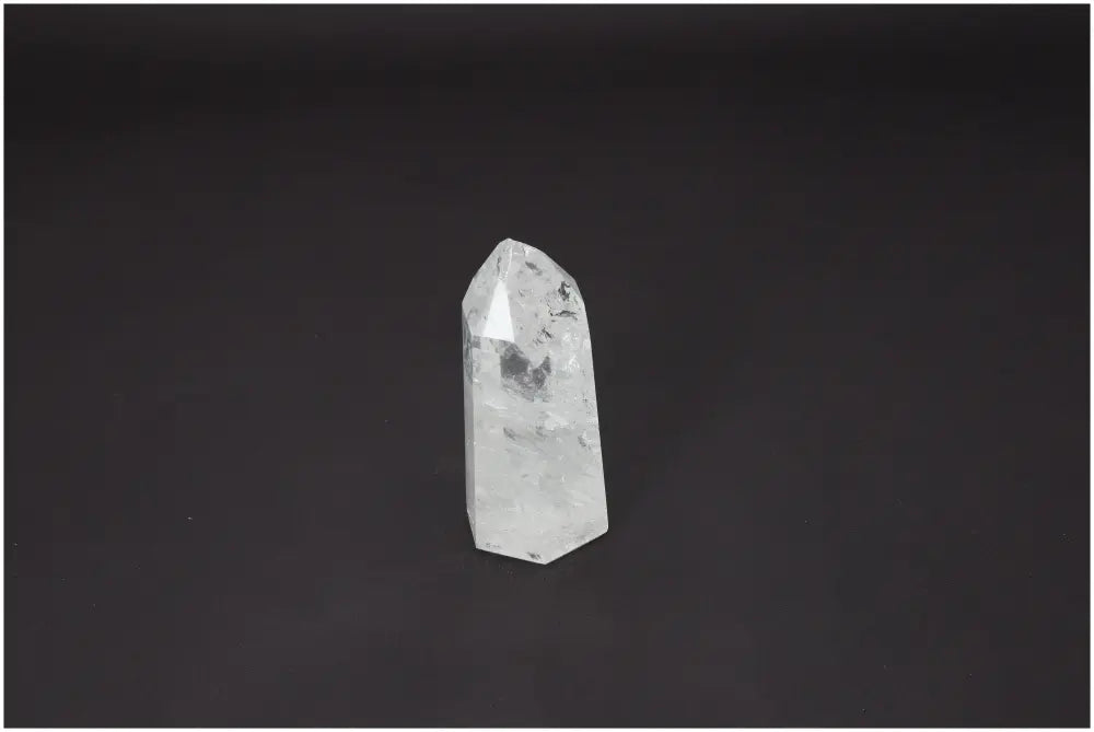 Lemurian Quartz Obelisk against black background, showcasing its clarity and energy properties for chakra and zodiac alignment.