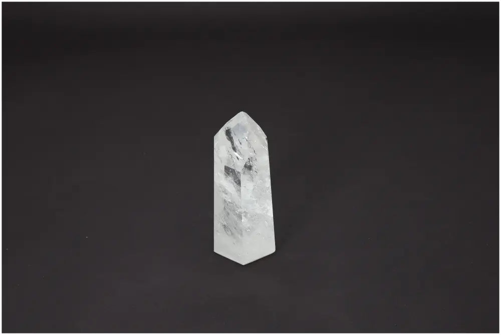 Lemurian Quartz Obelisk crystal on black background, enhances chakra energy and spiritual healing, associated with zodiac signs.