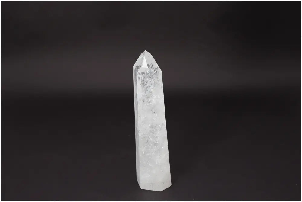 Lemurian Quartz Obelisk on dark background, known for clarity and healing, ethically sourced and naturally formed crystal.
