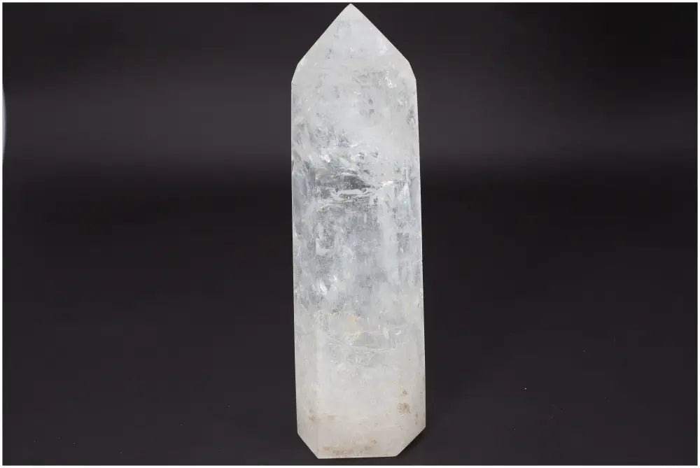 Lemurian Quartz Obelisk on black background, known for clarity and energy amplification, ethically sourced and naturally formed.
