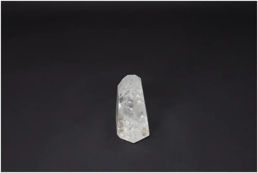 Lemurian Quartz Obelisk on dark background, known for amplifying energy and promoting clarity, balance, and personal growth.