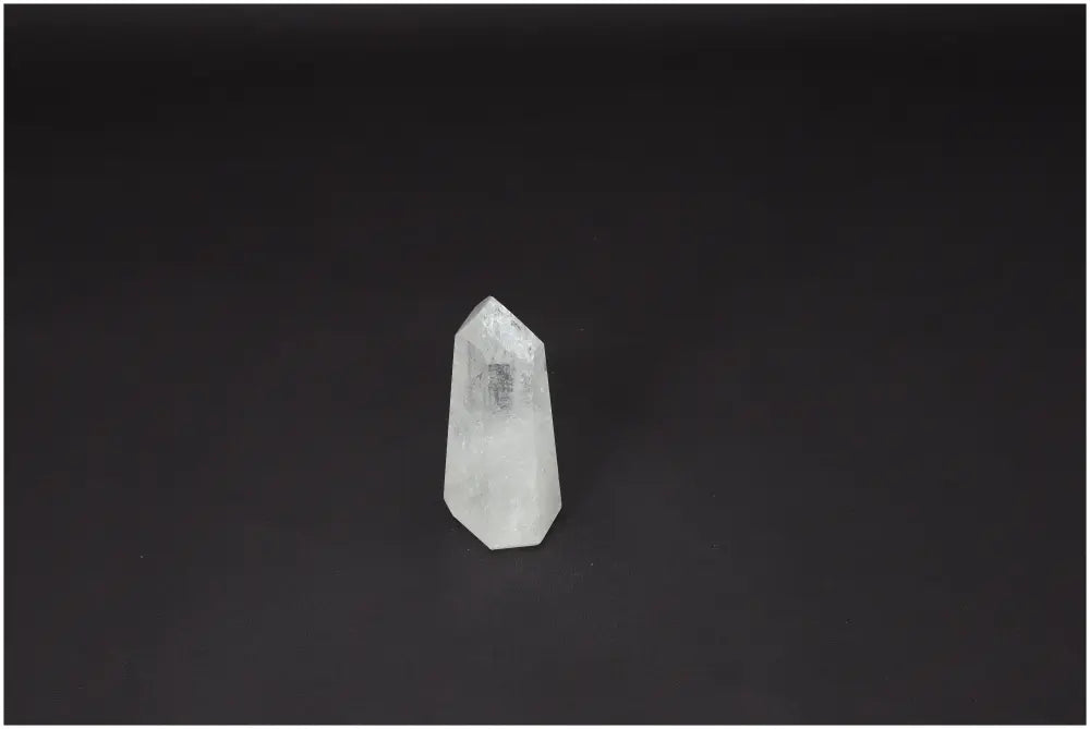 Lemurian Quartz Obelisk on dark background, showcasing its clarity and natural formation. Ideal for energy amplification and personal growth.