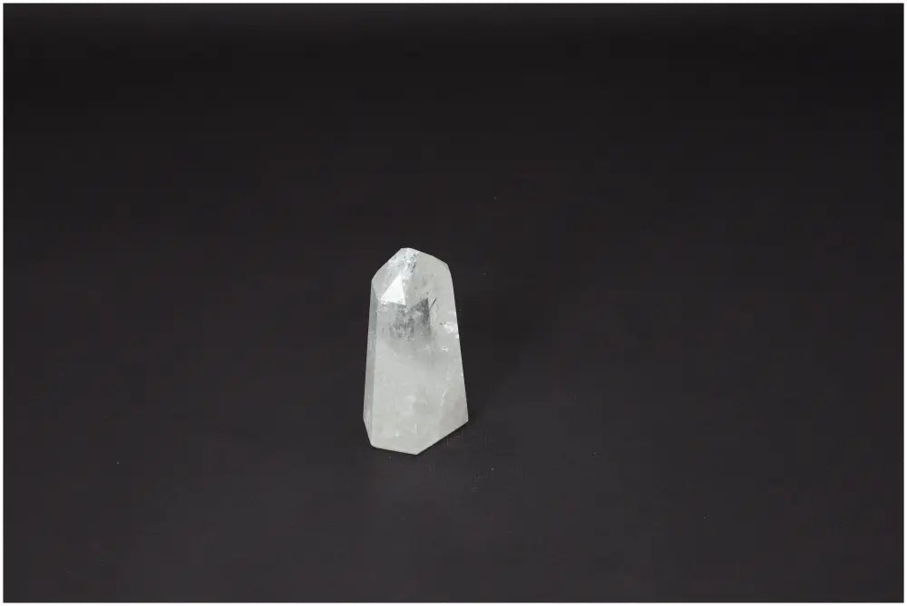 A hand-selected Lemurian Quartz Obelisk, known as a "Master Healer," enhancing clarity and balance, set against a dark background.