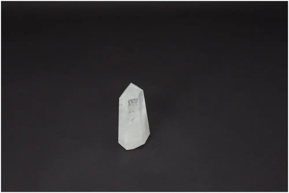Lemurian Quartz Obelisk against dark background, symbolizing clarity and balance. Master Healer crystal ethically sourced, powerful energy amplifier.