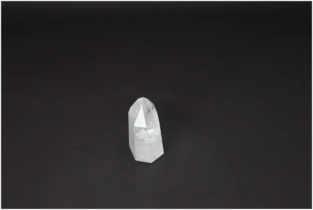 Lemurian Quartz Obelisk on dark background, Clear Quartz crystal known for amplifying energy, clarity, and balance, master healer.