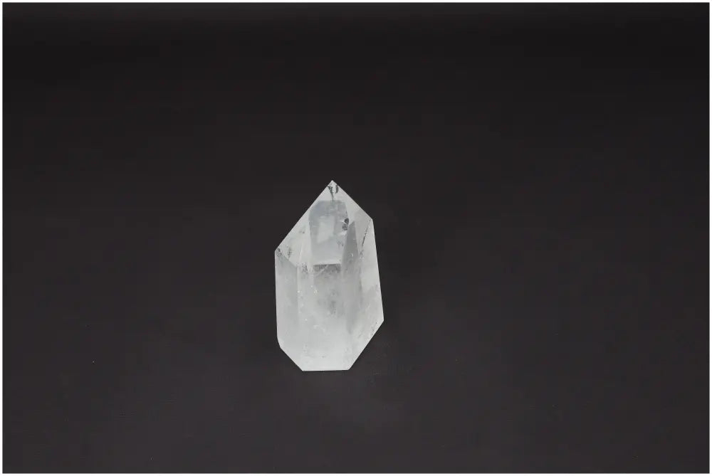 Lemurian Quartz Obelisk crystal on a dark background, known for clarity and balance in personal growth.