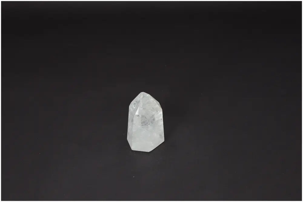 Lemurian Quartz Obelisk on black background, known for clarity and healing, ethically sourced and hand-selected crystal.