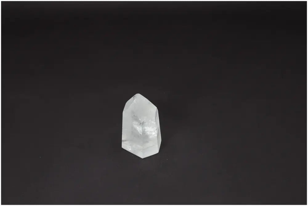 Lemurian Quartz Obelisk on a dark background, known for clarity and balance, ethically sourced and naturally formed.