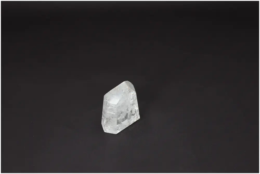 Clear Lemurian Quartz Obelisk for clarity and balance on black background, ethically sourced and hand-selected for quality.