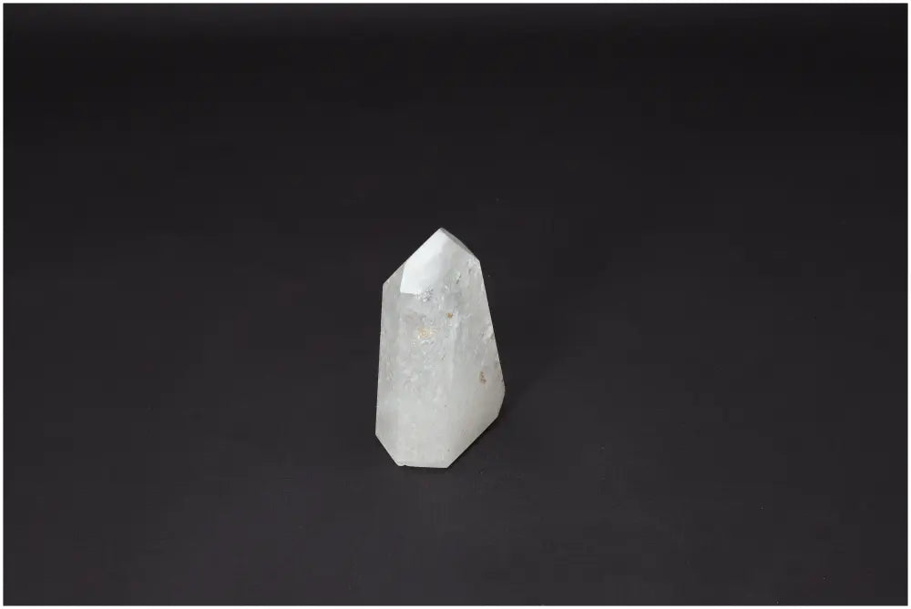 Lemurian Quartz Obelisk on black background, known for clarity and balance in crystal healing, amplifying energy and intentions.