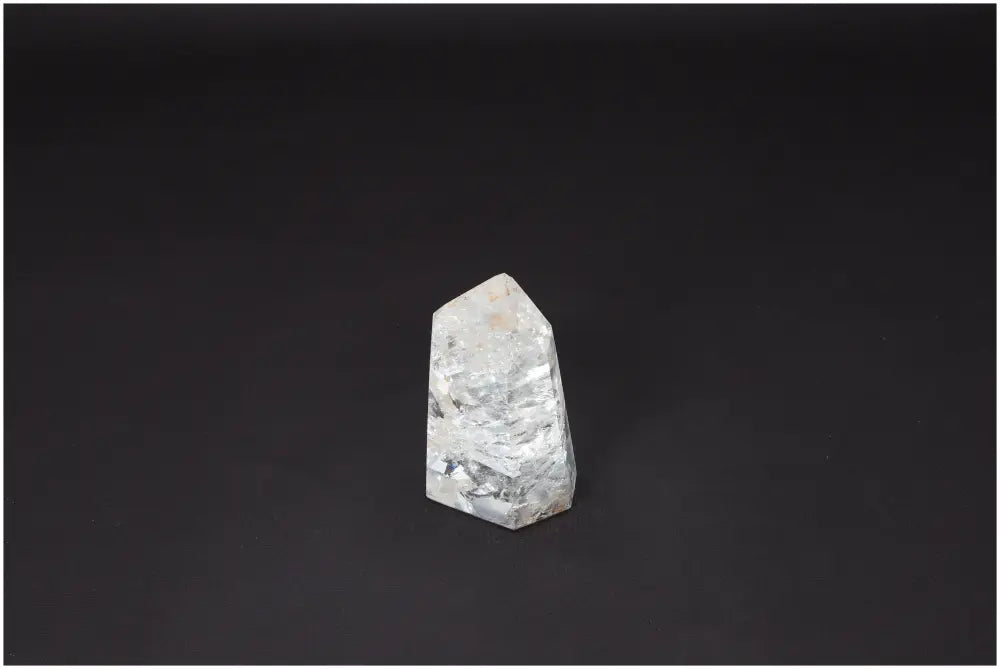 Lemurian Quartz Obelisk on black background, ideal for enhancing clarity and balance in personal growth. Ethically sourced, natural crystal.