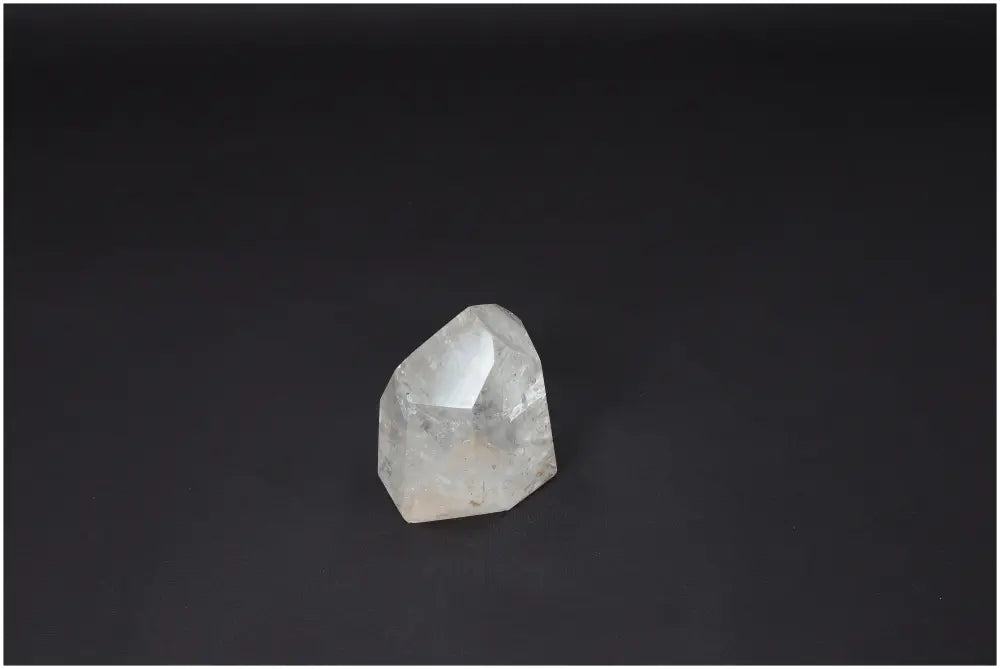 Clear Lemurian Quartz obelisk on dark background, known for enhancing clarity, balance, and personal growth.