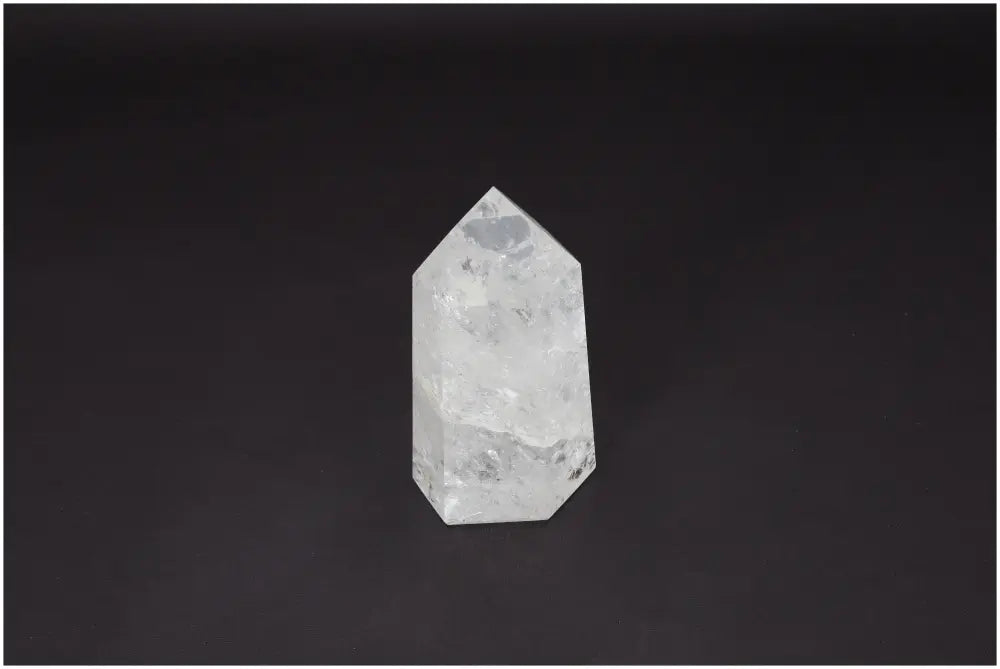 Lemurian Quartz Obelisk, ethically sourced clear quartz for clarity, balance, and personal growth, on a dark background.